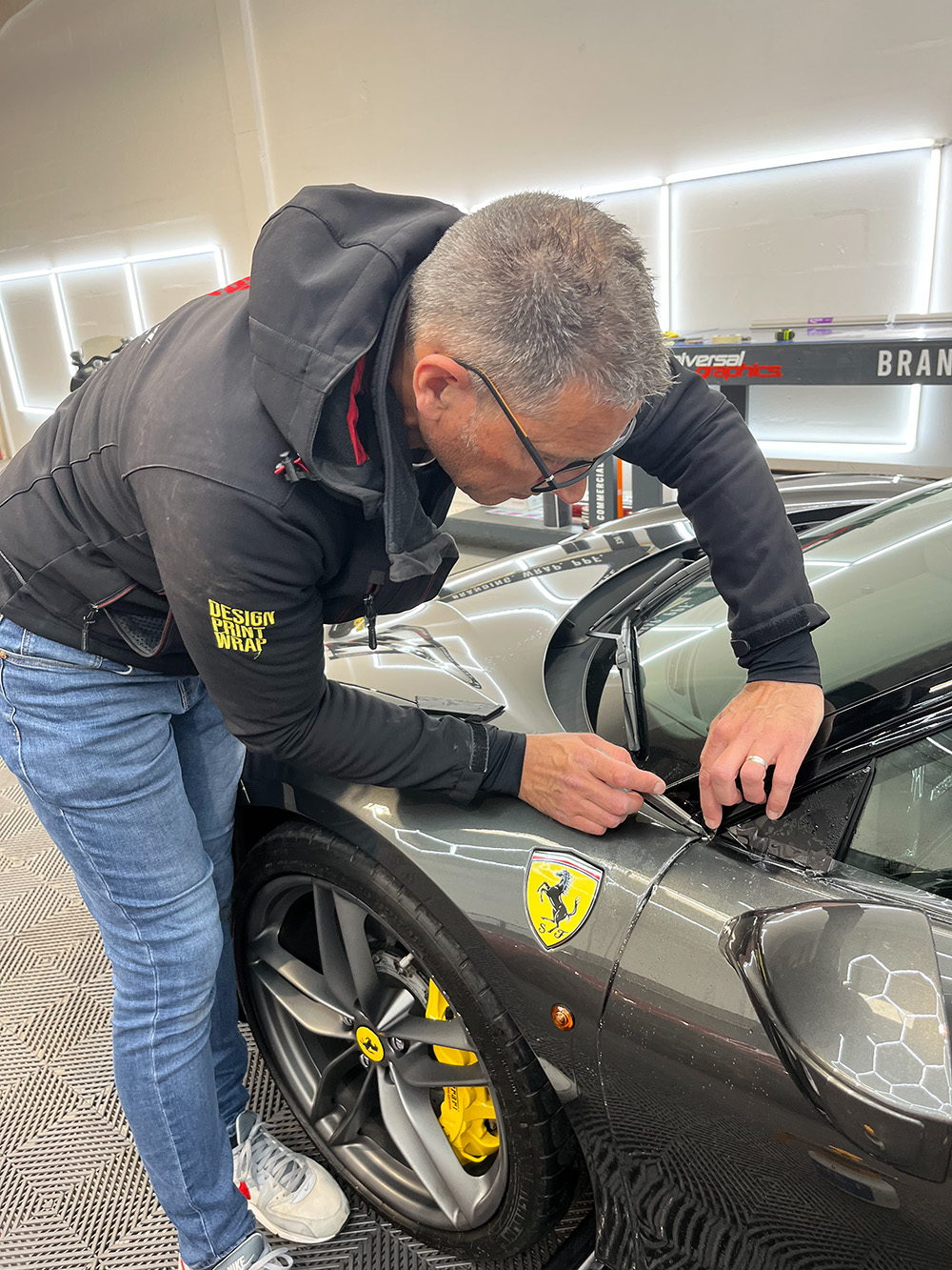 PPF being trimmed on a Ferrari